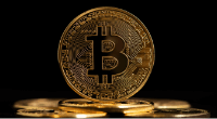 Golden bitcoin token on black background